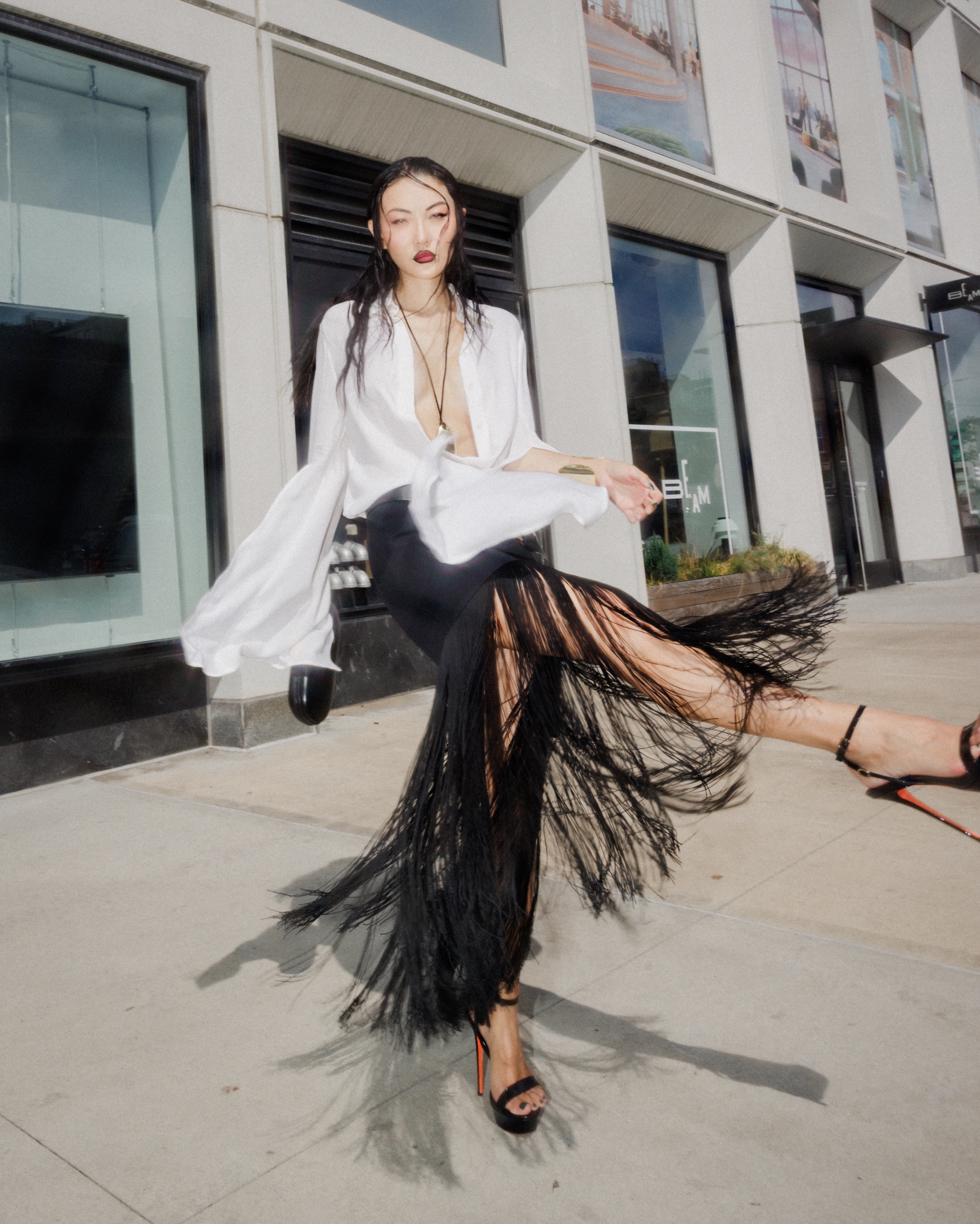 Jessica Wang in a black-and-white editorial look with long hair moving across her face