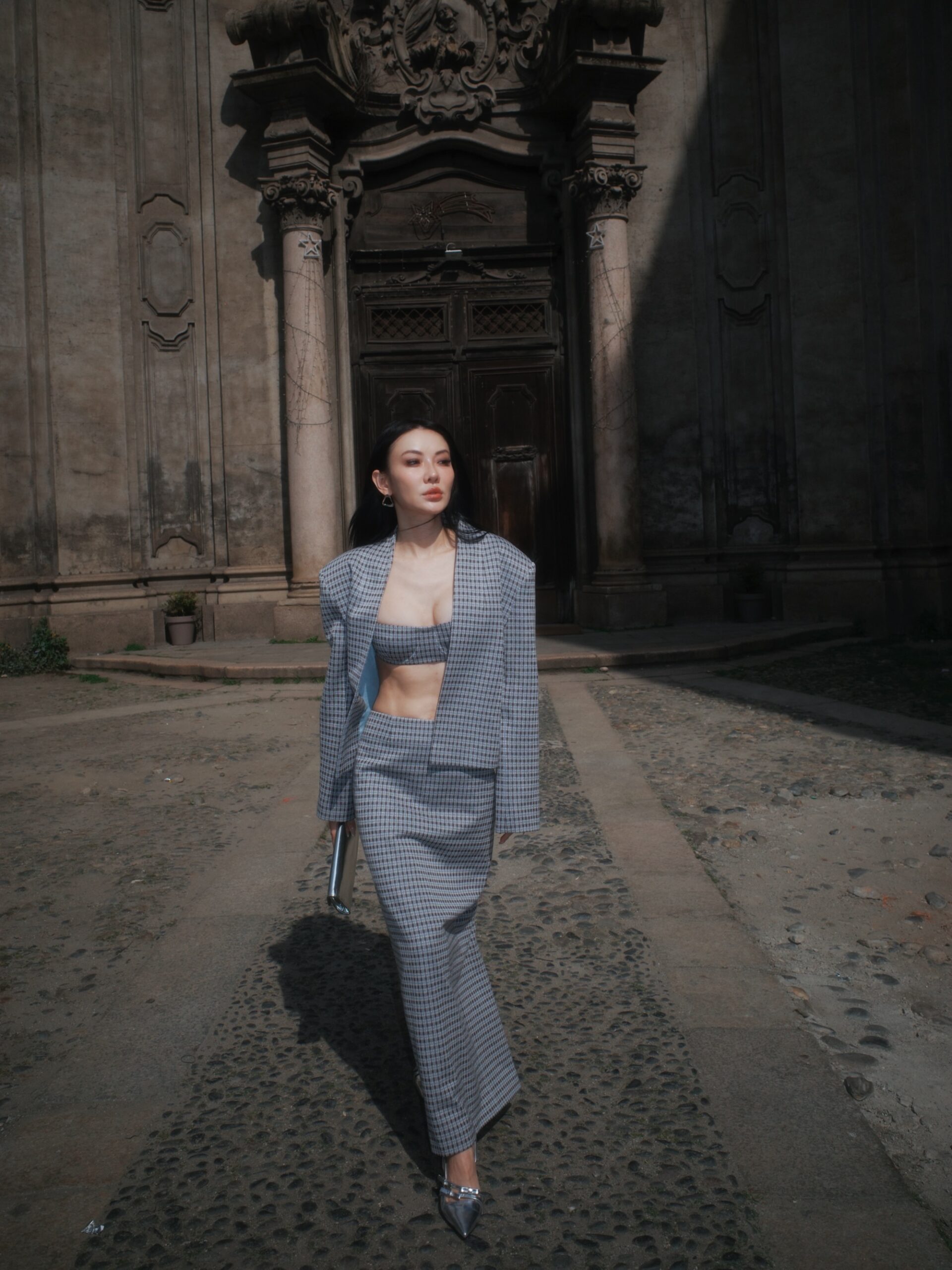 Jessica Wang wearing a gray tailored jacket with matching wide-leg trousers