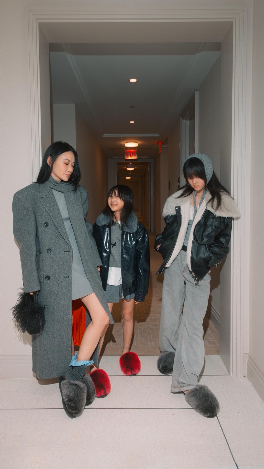 Jessica Wang in a gray longline blazer with a structured black shoulder bag