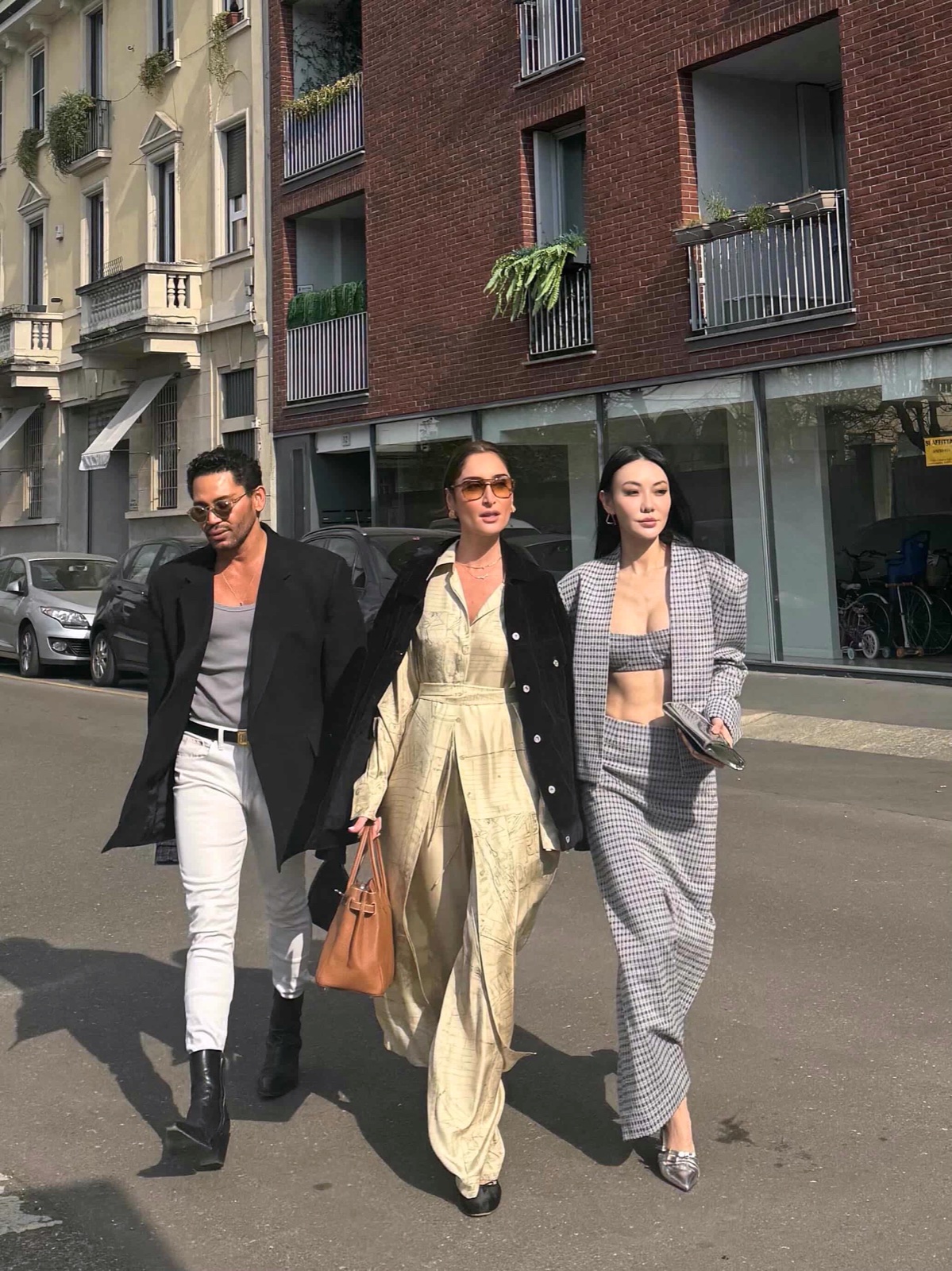 Jessica Wang in a gray houndstooth tailored look with a pointed silver shoe