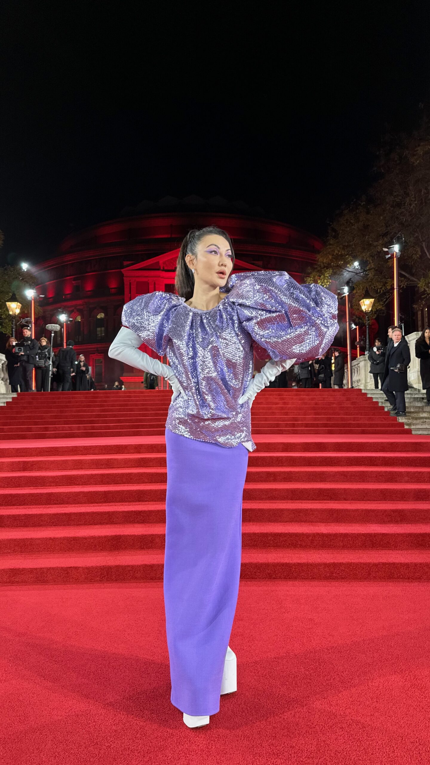 Close view of Jessica Wang's reflective purple top paired with a matte royal-purple skirt.